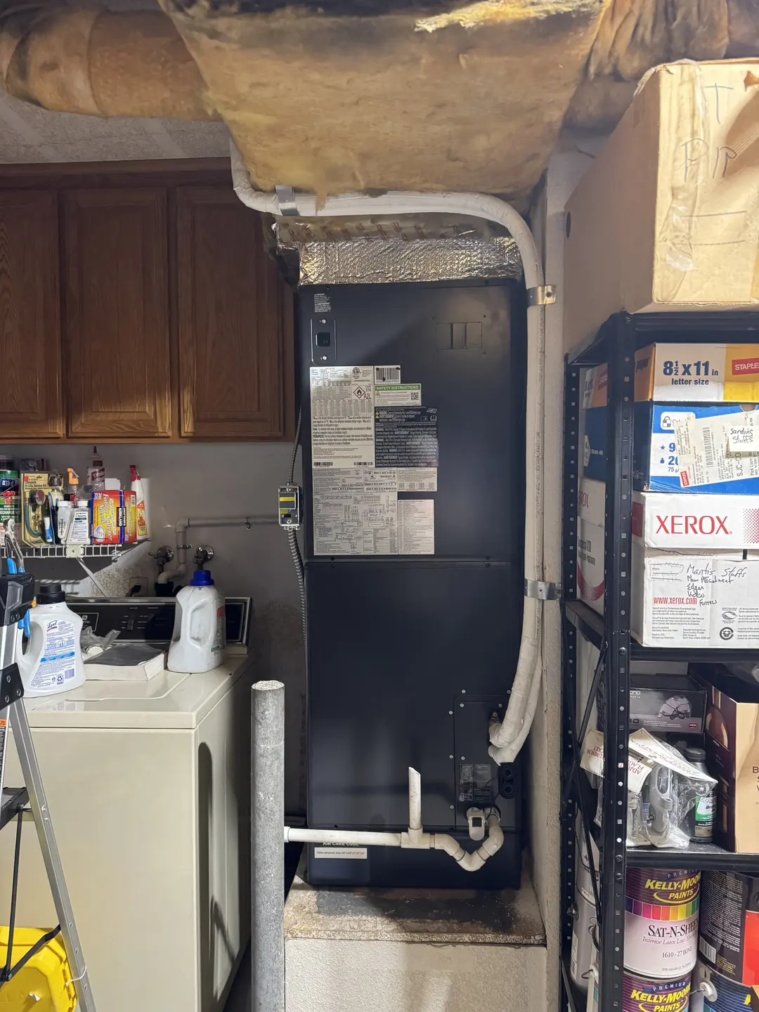 Vertical Carrier air handler installed on a raised platform in a West Los Angeles utility room next to a residential gas water heater